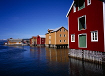 Norway, Nordland, Mosjoen, Well maintained  colourful facades of warehouses beside the southern end of Vefsnfjorden.