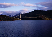 Norway, Nordland, Skjombrua Bridge, Suspension bridge above Skjomenfjord carrying main E6 Highway.  From north of Grinfjord with mountain backdrop.