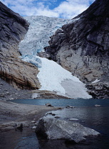 Norway, Sogn og Fjordane, Jostedalsbreen , Briksdalsbreen  one of several glacial tongues extending from the Jostedalsbreen glacier with meltwater lake and densely wooded area in foreground.