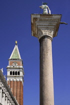 Italy, Venice, Piazzetta di San Marco, Campanile di San Marco, St Mark's Campanile or bell tower with a pillar and statue of St Theodore.