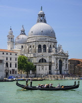Italy, Venice, Church of Santa Maria della Salute from across the Grand Canal with a gondolas crossing  in the foreground.