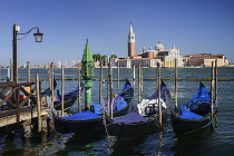Italy, Venice, Island and Church of San Giorgio Maggiore with gondolas in the foreground along the waterfront of the Piazzetta San Marco.