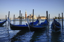 Italy, Venice, Island and Church of San Giorgio Maggiore with gondolas in the foreground along the waterfront of the Piazzetta San Marco.