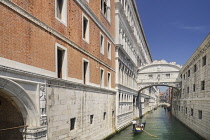 Italy, Venice, Doge's Palace and Bridge of Sighs with gondolas passing.