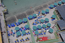 Italy, Campania, Amalfi Coast, Sorrento, Aerial view of beach with sunbeds.