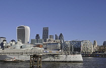 England, London, The view over the River Thames to the Modern Skyline of City of London with the Walkie Talkie and Cheesegrater and The Gherkin Buildings with HMS Belfast moored on River.