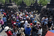 Indonesia, Java, Borobudur, People crush in the midday heat.