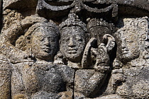 Indonesia, Java, Borobudur, Detail of three women's faces, weathered over time.