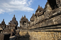 Indonesia, Java, Borobudur, Upper gallery, showing seated Buddhas in niches and bas-reliefs along the walls.