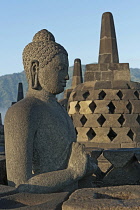 Indonesia, Java, Borobudur, Seated, granite Buddha with small stupas in the background