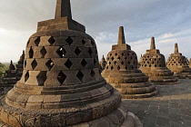 Indonesia, Java, Borobudur, Row of stupas on the top level of the monument.