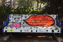 India, Maharashtra, Mumbai, Park bench painted with huge lips saying, 'Tonite's Gonna Be a Good Nite!!', with a cartoon rat with sunglasses sitting beside them