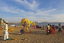 India, Maharashtra, Mumbai, Balloon and toy windmill seller on Chowpatty Beach
