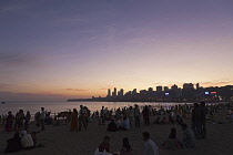 India, Maharashtra, Mumbai, Crowd on Chowpatty Beach at dusk.