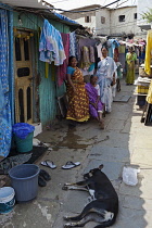 India, Maharashtra, Mumbai, Women standing outside their homes in a lane in a slum in Colaba.