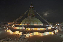 Nepal, Kathmandu, The Great Stupa at night, decorated with coloured lights in celebration of a full moon.