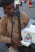 India, Maharashtra, Mumbai, Instant photo: local photographer with a portable printer, at the Gateway for India.