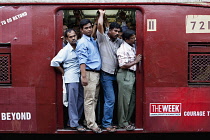 India, Maharashtra, Mumbai, Commuters on a crowded suburban train.