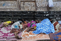 India, Maharashtra, Mumbai, Homeless family asleep on a pavement in central Bombay.