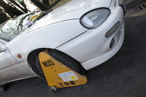 Transport, Road, Cars, Ticket placed on windscreen of clamped untaxed vehicle.