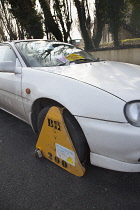 Transport, Road, Cars, Ticket placed on windscreen of clamped untaxed vehicle.