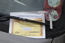 Transport, Road, Cars, Ticket placed on windscreen of clamped untaxed vehicle.