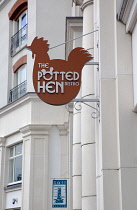 Ireland, North, Belfast, Cathedral Quarter, Exterior sign for the Potted Hen restaurant in St Annes Square.