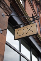 Ireland, North, Belfast, Wooden sign for the Ox restaurant on Oxford Street.