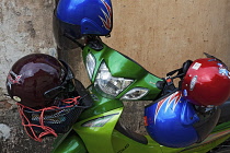 Laos, Vientiane, One motorbike parked with four helmets.