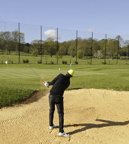 Sports, Ball, Golf, Male Golfer playing from a Bunker at the Practice Ground.