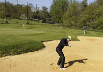 Sports, Ball, Golf, Male Golfer playing from a Bunker at the Practice Ground.