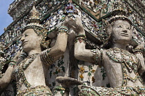 Thailand, Bangkok, Wat Arun, Ramayama demons and fragments of Chinese porcelain encrusting the sides of the Temple of the Dawn.