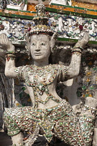 Thailand, Bangkok, Wat Arun, Ramayama demons and fragments of Chinese porcelain encrusting the sides of the Temple of the Dawn.