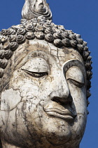 Thailand, Sukothai, Close up of white, cracked face of a Buddha, Wat Trapang Ngoen.