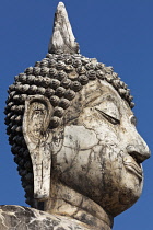 Thailand, Sukothai, Close up of white, cracked head and face of a Buddha, Wat Trapang Ngoen.