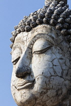 Thailand, Sukothai, Close up of white, cracked face of a Buddha, Wat Trapang Ngoen.