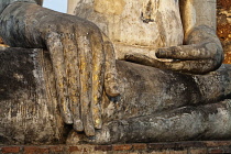 Thailand, Sukothai, Close up of the hand, with remains of gold paint, of a seated Buddha, Wat Mahathat Royal Temple.
