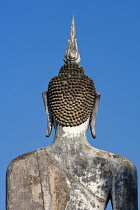 Thailand, Sukothai, Rear view of seated Buddha statue, Wat Mahathat Royal Temple.