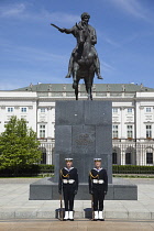 Poland, Warsaw, Old Town, Krakowskie Przedmiescie, Radziwill Palace Presidential Residence with guards in front of statue of Prince Jalzef Poniatowski.