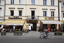 Poland, Warsaw, Nowy Swiat, Exterior of restaurants with tables outside.