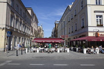 Poland, Warsaw, Nowy Swiat, Exterior of restaurants with tables outside.