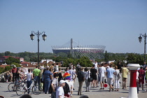 Poland, Warsaw, Old Town, Tourists next to St Annes Church with the Narodowy stadium in the back ground.