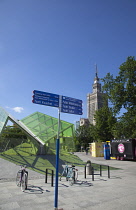 Poland, Warsaw, Centrum, Palace of Culture and Science, a gift from Russia in 1955 with modern glass Metro entrance in the foreground.