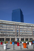 Poland, Warsaw, Plac Powstancow Warzawy, Colourful planters out side modern office building.