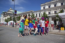 Poland, Warsaw, Old Town, Krakowskie Przedmiescie, teenagers dressed as clown as part of festival.