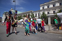 Poland, Warsaw, Old Town, Krakowskie Przedmiescie, teenagers dressed as clown as part of festival.