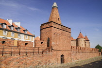 Poland, Warsaw, Old Town, City wall with Barbakan or Barbican defensive gate in the background.