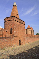 Poland, Warsaw, Old Town, City wall with Barbakan or Barbican defensive gate in the background.