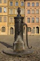 Poland, Warsaw, Stare Miasto or Old Town Square, West side of the square with 19th century iron water pump.