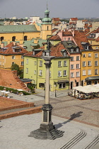 Poland, Warsaw, Castle Square, King Sigismund III Vasa Column with colourful roofscapes behind seen from St Anne's Church Viewing Tower.